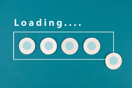 The word loading is standing over the progress bar, hand puts last cube to the row, business, education and marketing concept download a new program