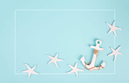 Blue colored summer and vacation background, anchor and sea stars building a frame, copy space for text, holiday and tourism concept