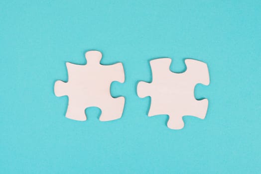 Two pieces of a puzzle, connecting together as a team, solving a problem, strategy and communication concept