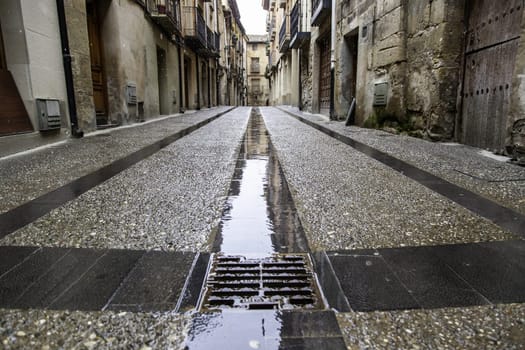 Wet stone street in old town, construction and architecture