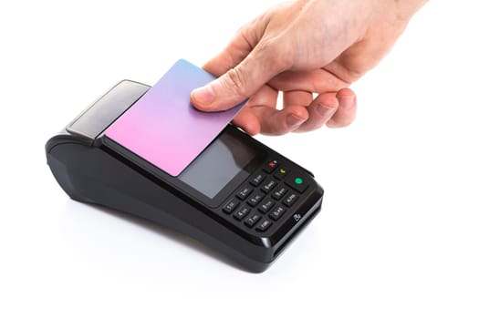 Attached plastic card to the payment terminal with a man's hand on a white isolated background, copy space. High quality photo