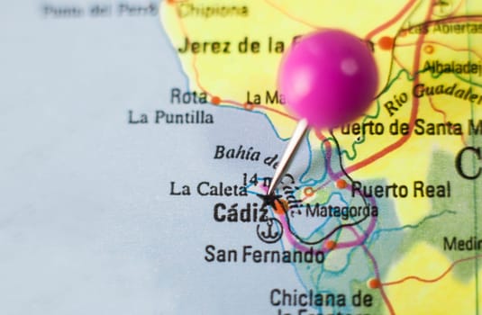 Pushpin marking on Cadiz, Spain. Selective focus on city name