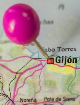 Pushpin marking on Gijon, Spain. Selective focus on city name