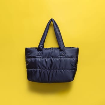 The bag is black textile on a yellow background with a shadow. A place for an inscription, a logo, a mockup.