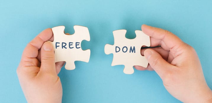 The word freedom is standing on puzzle pieces, new normal, covid-19 regulations, changing lifestyle, free speech