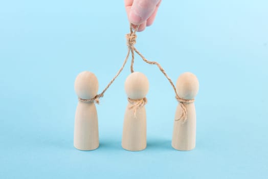 Holding and manipulating men with a string, brainwashing and controlling concept, people obey leader, political dictator and tyrant