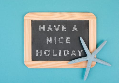 Empty chalkboard with a sea star, have a nice holiday, summer vacation, hot weather, advertising and marketing concept