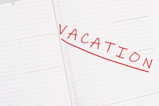 The word vacation is standing in the calendar, planning for the holiday, summer break