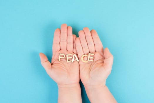 Holding the word peace in the hands, stop war, support Ukraine, living peaceful together