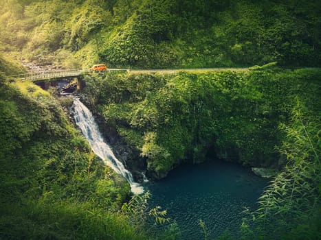 Makapipi Falls of Maui, the Road to Hana in Hawaii. Beautiful waterfall underneath the highway bridge. Wonderful cascade in the in hawaiian rainforest among tropical green fern vegetation