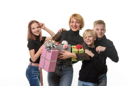 Children congratulated their mother on her birthday, look into the frame together and smile