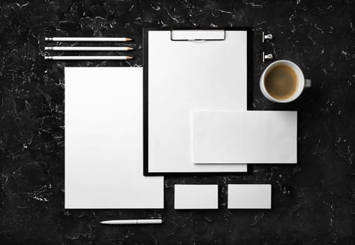 Branding stationery mockup on black plaster background. Blank objects for placing your design. Flat lay.