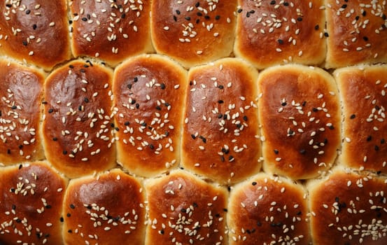 Fresh delicious sweet buns with sesame seeds. Flat lay.