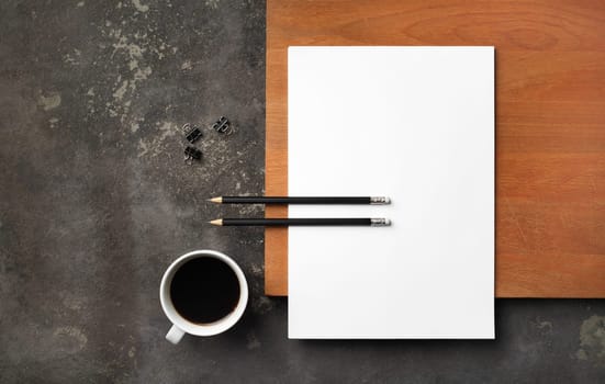 Blank letterhead, pencils, coffee cup and clips. Responsive design template. Flat lay.