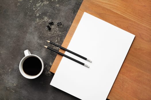 Blank paper, pencils, coffee cup and clips. Copy space for text. Corporate identity template. Flat lay.