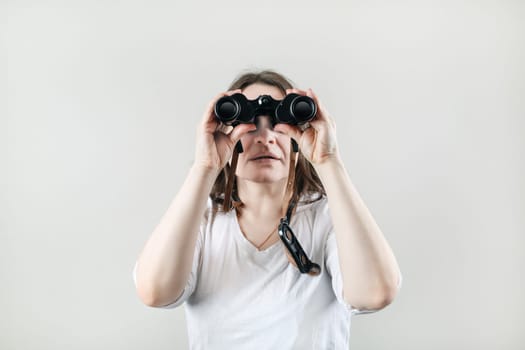 Woman with binocular. Businesswoman looking through binoculars.
