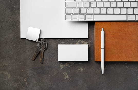 Blank real estate agency stationery set. Blank business card, key, keyboard, pen and paper. Flat lay.