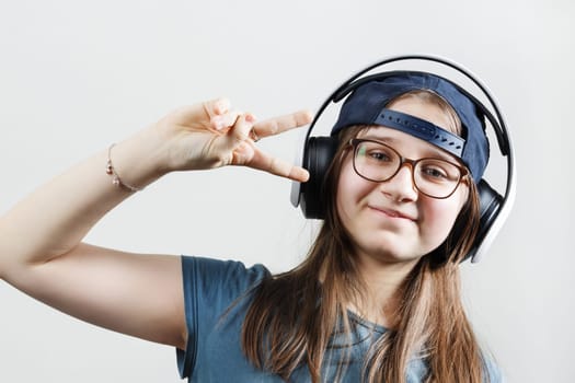 Teen girl wearing headphones listening to music.