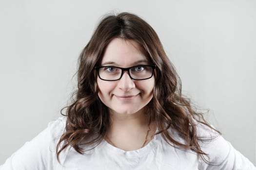 Woman wearing glasses. Businesswoman smiling and looking at camera.