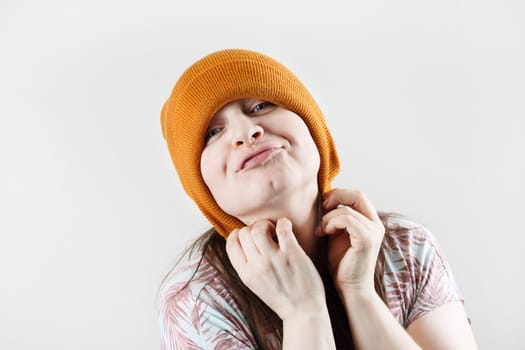 Smiling hipster woman pulled a knitted hat over her ears.