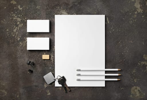 Blank stationery set and keys on concrete background. Blank objects for placing your design. Flat lay.
