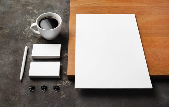 Corporate identity template. Blank letterhead, business cards, pen, coffee cup and clips.