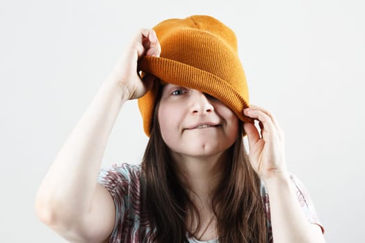 Hipster woman peeking out from under a knitted hat.