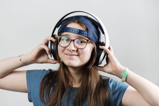 Smiling teen girl listening music in headphones. Enjoy music.