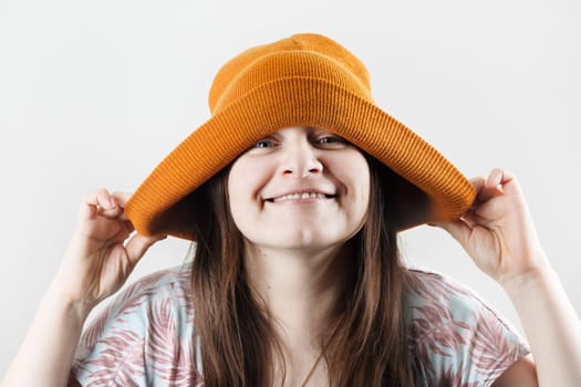 Happy cheerful hipster woman in knitted hat.