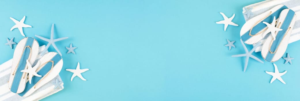 Blue colored summer and vacation background, slippers and sea stars building a frame, copy space for text, holiday and tourism concept