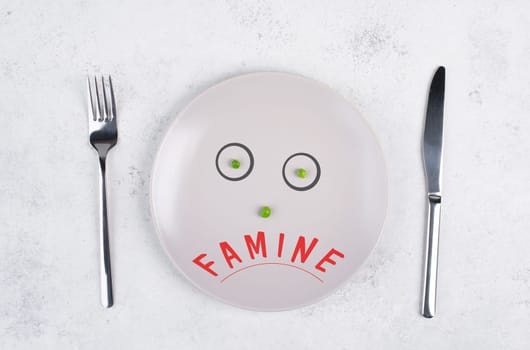 Famine is standing on the plate, food shortage and starving because of the war and inflation, political issue, face with green peas
