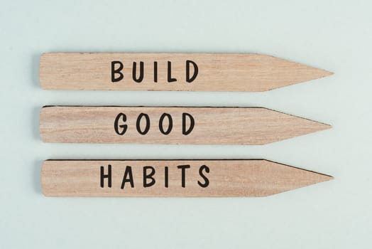 The words build good habits are standing on arrows, change lifestyle, healthy and positive attidude, motivation concept