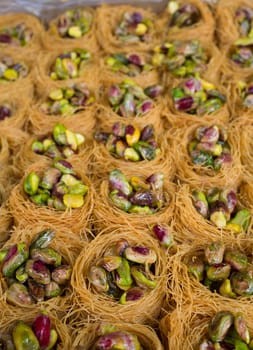 Platter crammed with Nightingales Nests or Ouch El Boulboul. Arabic dessert with pistachio