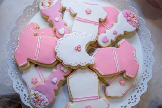 Platter full of baptism or christening cookies. Overhead view