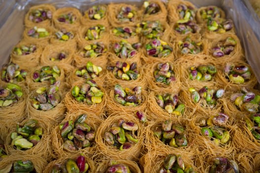 Platter crammed with Nightingales Nests or Ouch El Boulboul. Arabic dessert with pistachio