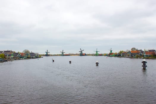 rural landscape with windmills at famous tourist site Zaanse Schans in the Netherlands