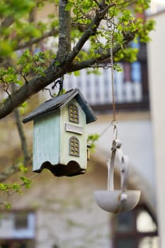 Wooden bird house as decoration in a tree in the garden