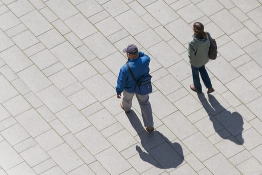 a couple walking through the city center of Magdeburg seen from above