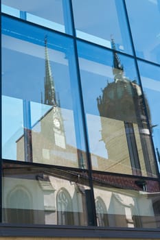 Reflection of the castle church Schlosskirche in Wittenberg in Germany in the glass of a window