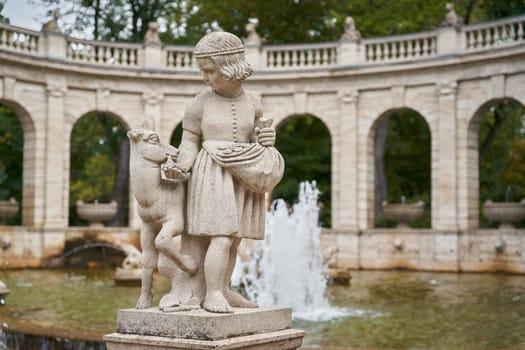 Figures from the fairy tale Bruderchen und Schwesterchen at the fairy tale fountain from 1913 in the popular Volkspark Friedrichshain in Berlin
