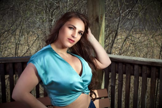 seductive woman outside blue retro style camisole make-up spring forest in a park
