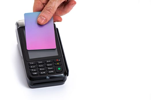 Attached plastic card to the payment terminal with a man's hand on a white isolated background, copy space. High quality photo