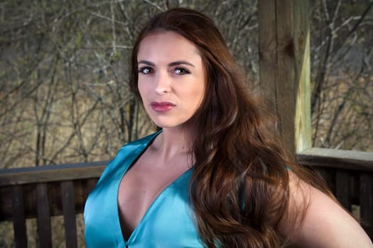 seductive woman outside blue retro style silk camisole make-up spring forest in a park