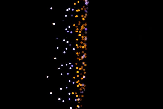 Black background with golden light effects vertical. background with  Blur bokeh effects. Abstract background texture