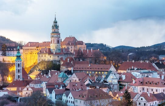 Beautiful view to Cesky Krumlov castle and its tower in Czech republic at sunset with dramatic clouds. Horizontally.
