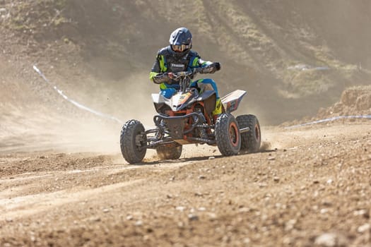 MOHELNICE,  CZECH REPUBLIC - APRIL 16, 2022: Rider on blue  quad bike is driving in International Championship of Czech Republic in Sidecarcross, category Quad on April 16, 2022 in Mohelnice.