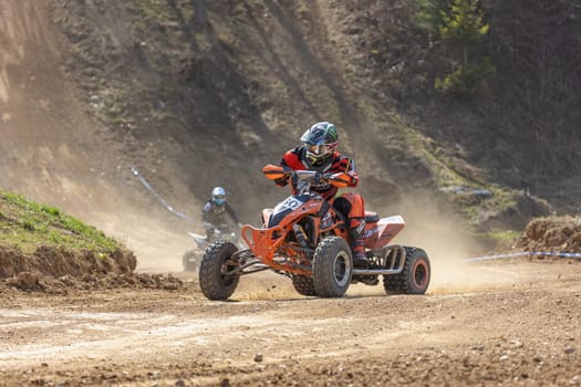 MOHELNICE,  CZECH REPUBLIC - APRIL 16, 2022: Two quad bike riders in right turn in International Championship of Czech Republic in Sidecarcross, category Quad on April 16, 2022 in Mohelnice.