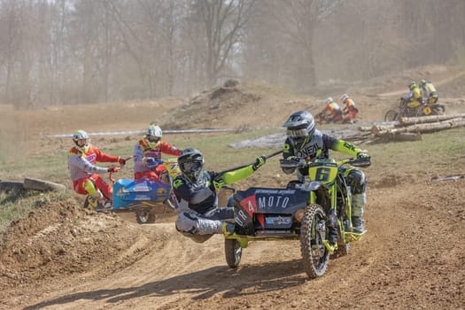 MOHELNICE, CZECH REPUBLIC - APRIL 16, 2022. Group of riders in sidecarcross race - "Sidecarcross Championship of Czech Republic"" on April 16, 2022 in the town of Mohelnice, Czech Republic."