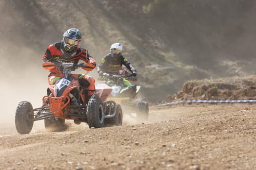 MOHELNICE,  CZECH REPUBLIC - APRIL 16, 2022: Two riders on a quad bike in the dust in International Championship of Czech Republic in Sidecarcross, category Quad on April 16, 2022 in Mohelnice.