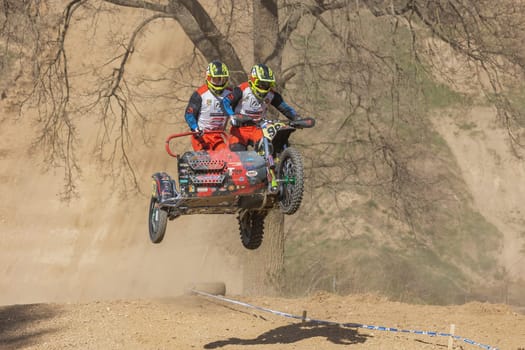 MOHELNICE, CZECH REPUBLIC - APRIL 16, 2022. Sidecacross motorbike in high jump in the "Sidecarcross Championship of Czech Republic"" on April 16, 2022 in the town of Mohelnice."